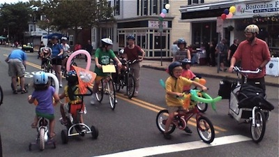 Kids riding with parents on Highland Avenue
